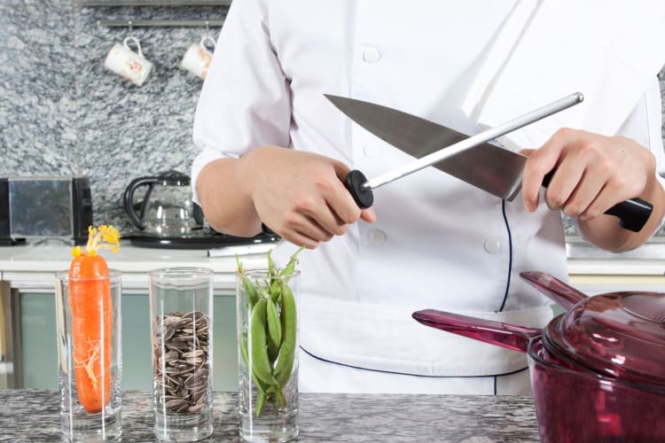 chef sharpening a knife