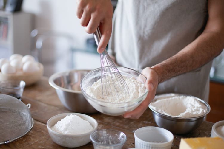 a person mixing ingredients for baking