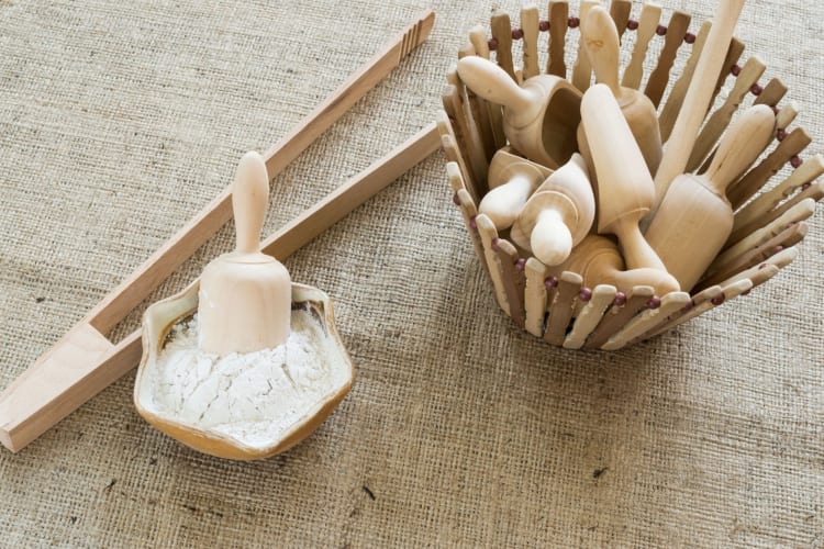 Flour scoops next to tongs and a bowl of arrowroot — an excellent cornstarch substitute
