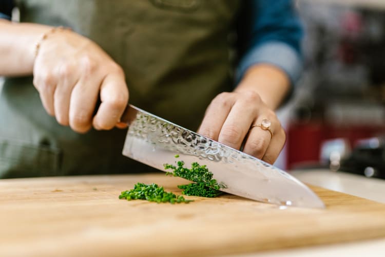 Hand positioning is important when cutting basil or other foods.