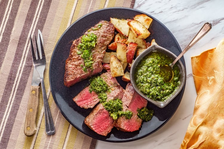 steak and potatoes with green sauce