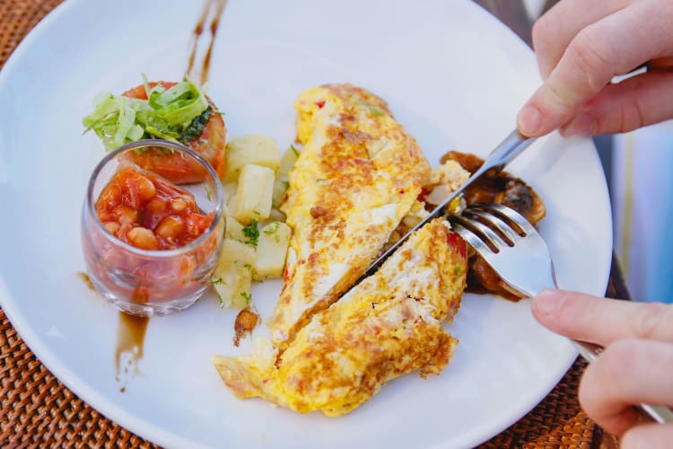 cutting an omelette with a dinner knife