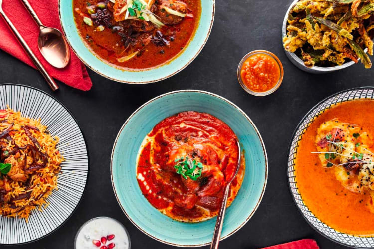 Top view of different curry dishes on a table