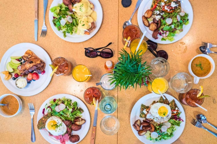 Topview of breakfast dishes on a yellow table