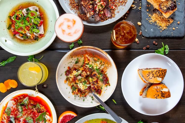 Topview of a range of colourful food dishes on a wooden table