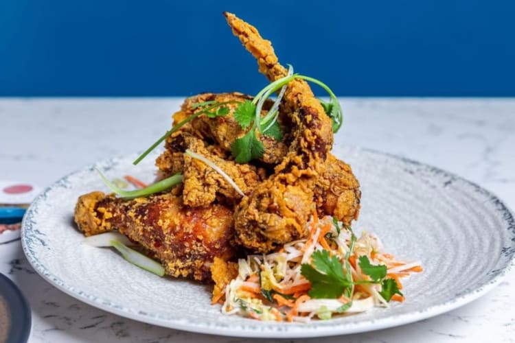 a plate with fried chicken and salad