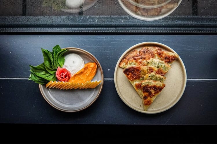 Two different plates of food from the D.C. restaurant Rooster & Owl