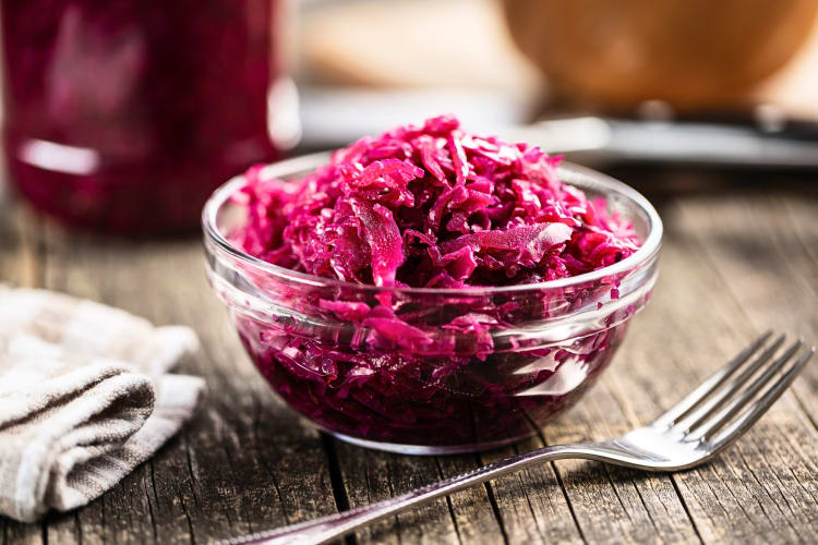 Red pickled cabbage in a transparent bowl