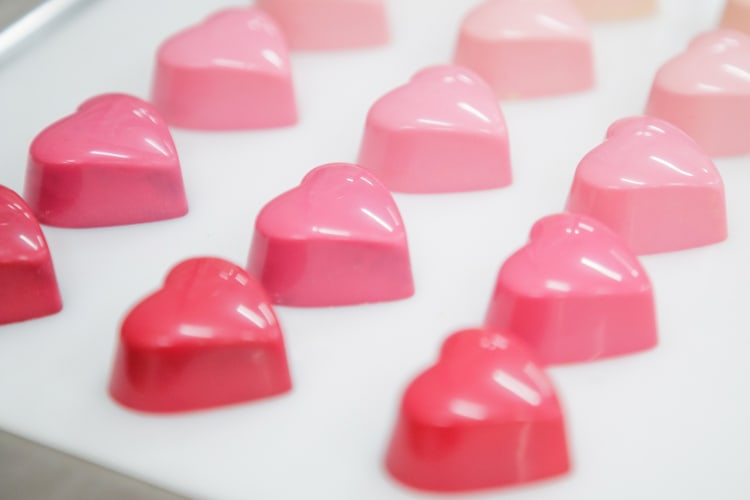 Heart-shaped, well tempered ruby chocolate truffles