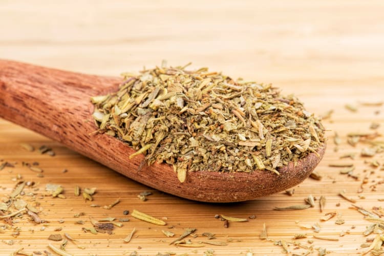A wooden spoon with an Italian seasoning mix