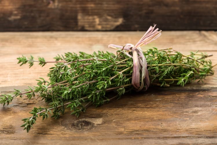 A bunch of thyme on a wooden surface
