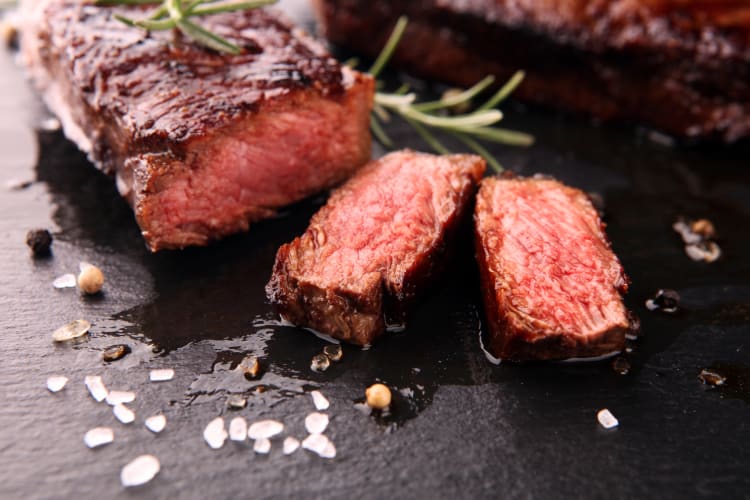 Wagyu beef sliced up with salt, pepper and garnish on top