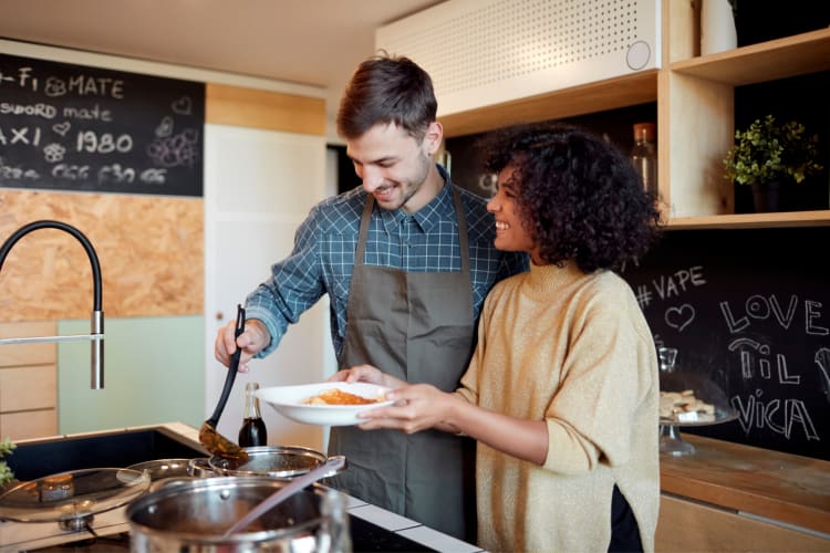 A couple making dinner in a kitchen