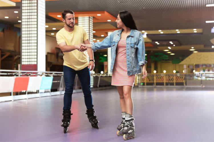 A couple skating at a roller rink