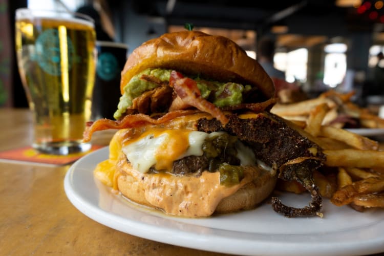 A burger and a beer on a table