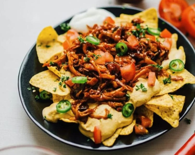 loaded vegan nachos with mushroom pulled pork is a savory and satisfying vegan appetizer