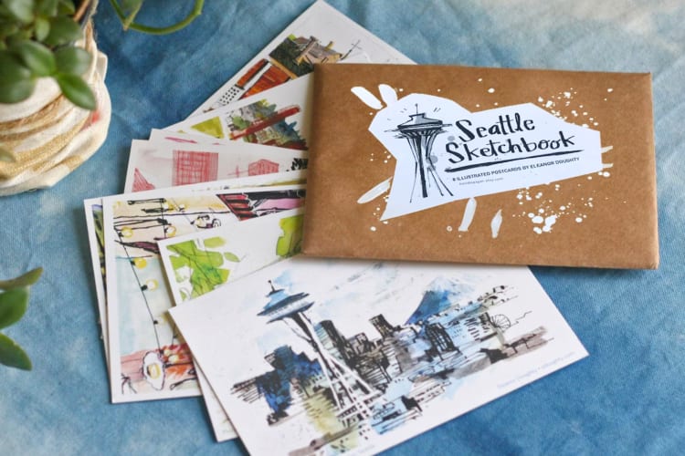 Colorful postcards and a brown envelope on a blue cloth