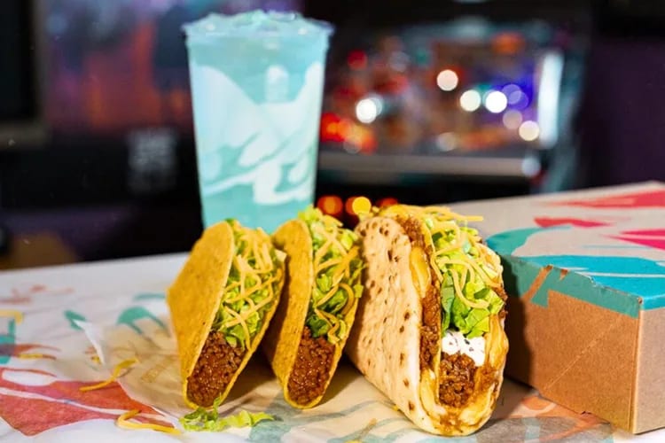 A selection of tacos and a blue drink