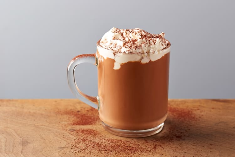 Side view of a hot chocolate topped with whipped cream