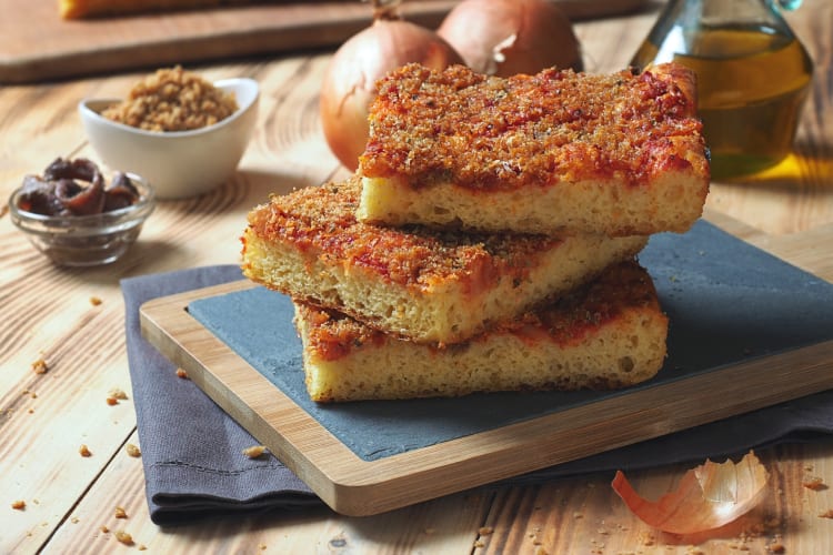 Three slices of sfincione stacked on top of one another