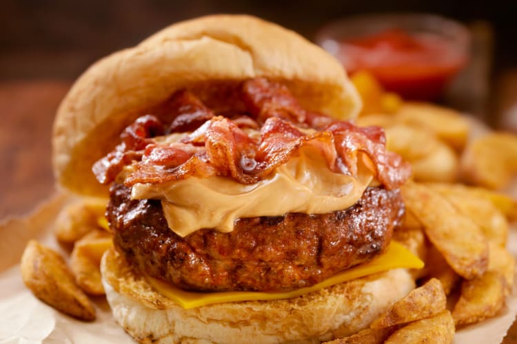 A burger with bacon and peanut butter