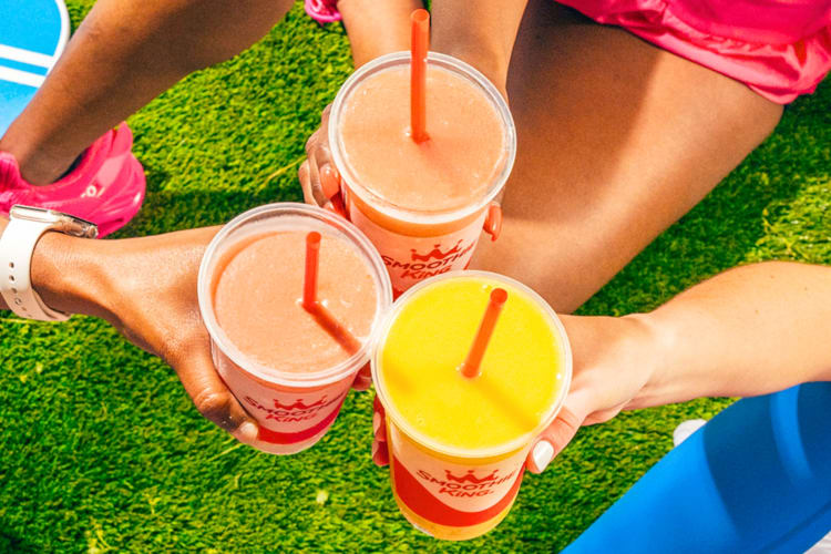 People holding different smoothies