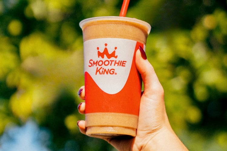 A person holding a smoothie