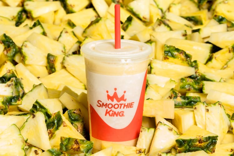 A pineapple smoothie and fresh pineapple