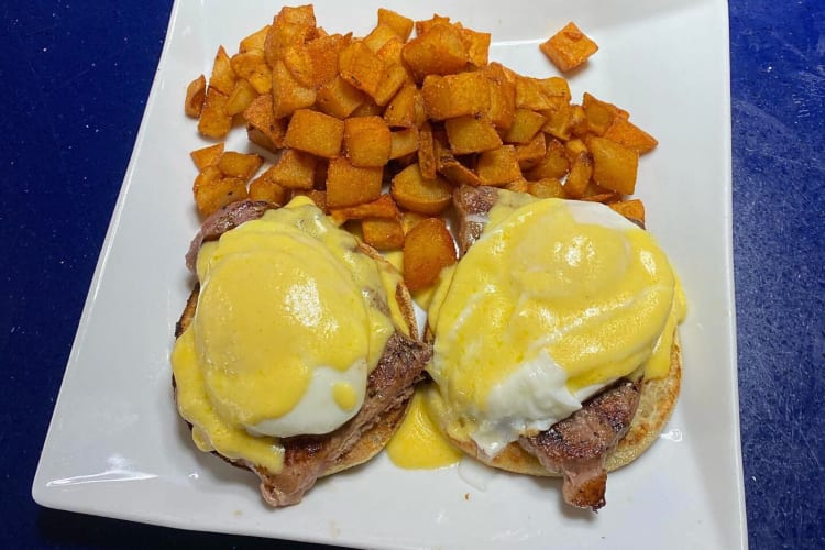 Breakfast meal from South Street Diner in Boston, featuring eggs, meat and fries cubes