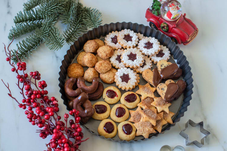 German Christmas cookies on a tray, surrounded by decorations