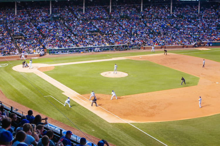 Wide view of a baseball match taking place with the crowd in the background