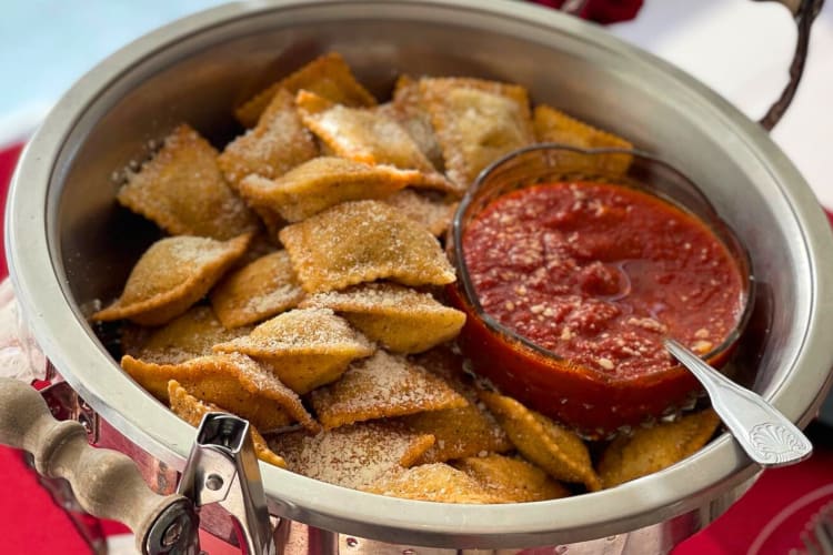 Toasted ravioli in a bowl with marinara sauce