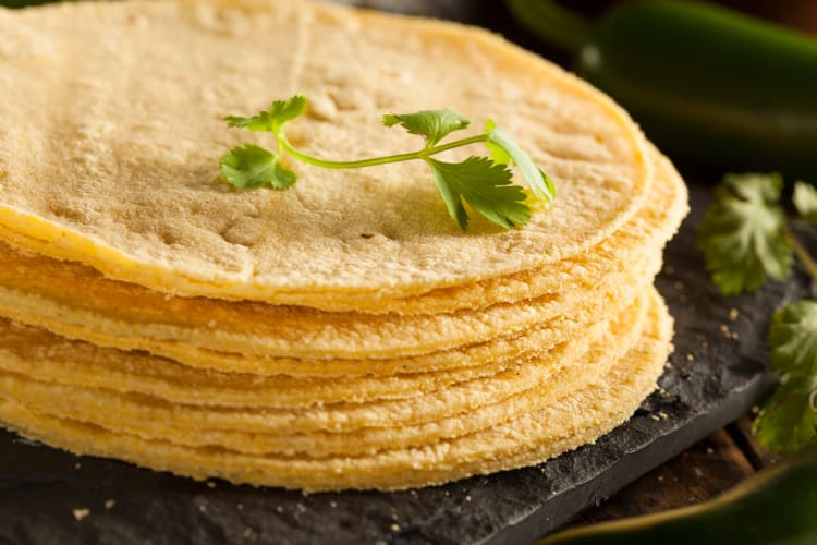 Stack of tortillas with garnish on top