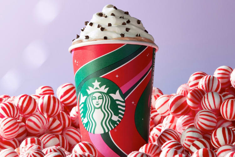 A Starbucks holiday drink cup and peppermint candies