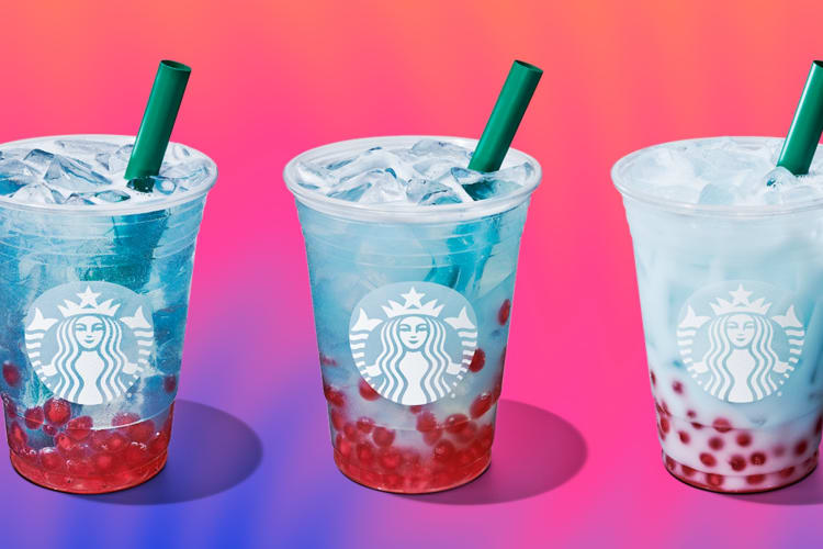 Three blue drinks with boba on a pink background