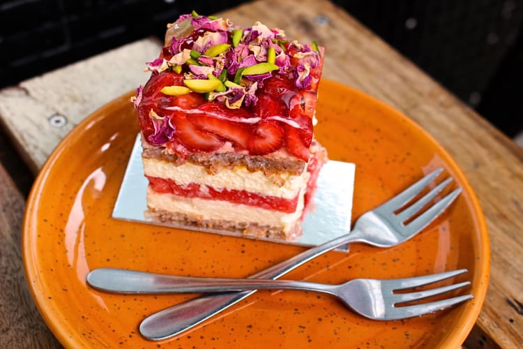 Strawberry and watermelon cake on a plate with two forks