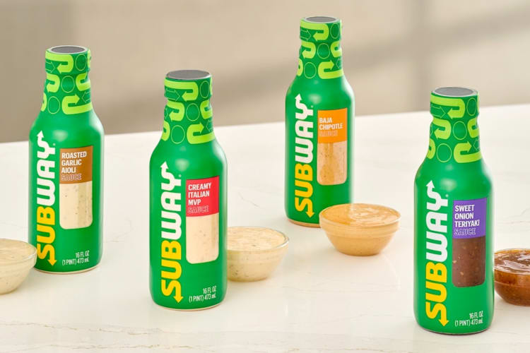 Four different flavors of Subway sauce in green bottles