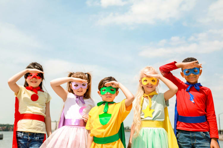 Kids dressed in superhero costumes