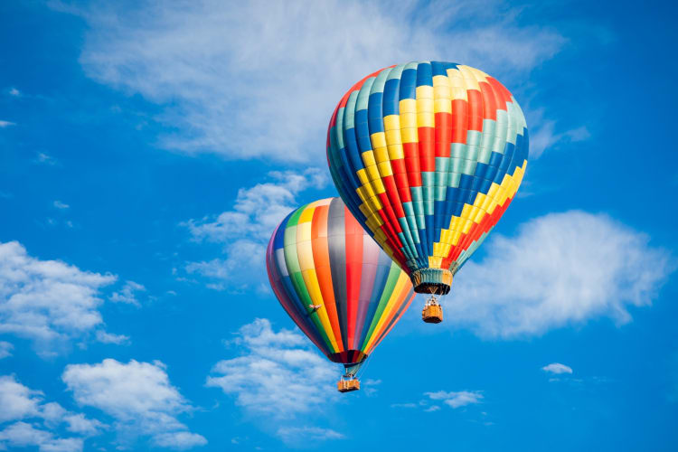 Two colorful hot air balloons in the sky