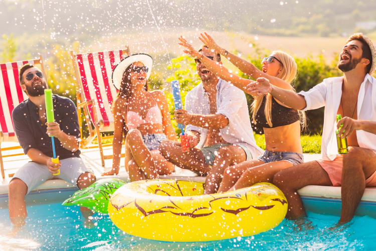 People sitting around a pool at a party