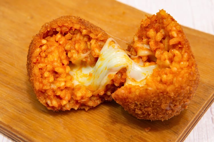 A delicious Rome food called suppli, broken in half