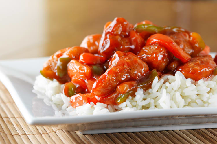 Sweet and sour pork dish on a white plate