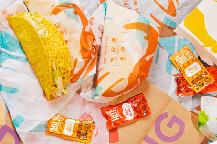 Taco Bell tacos and sauce packets on a table
