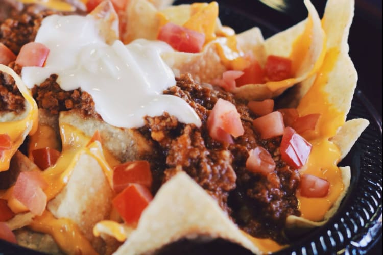 Chili nachos with cheese and tomatoes