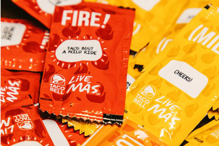 Packets of red fire hot sauce and yellow mild sauce