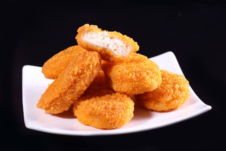 Chicken nuggets on a white plate
