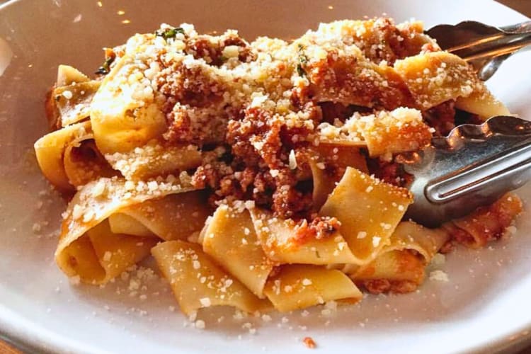 Pappardelle pasta topped with ground meat and cheese, from Tavolàta