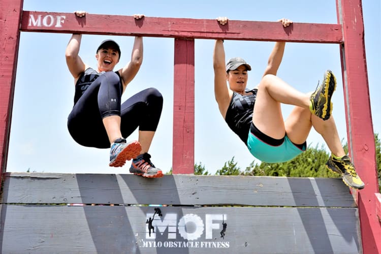 Two women doing an obstacle course