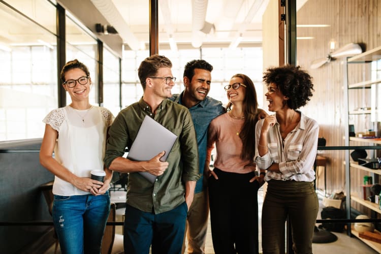 A group of co-workers laughing together