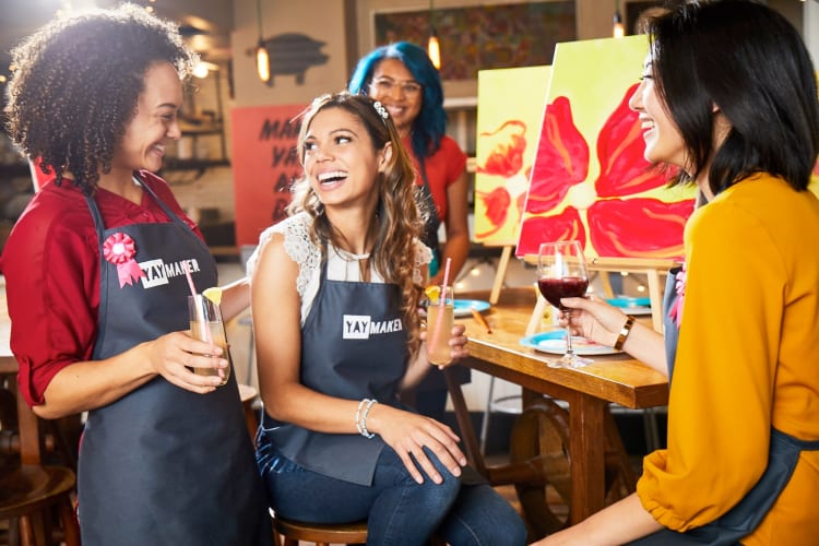 People having drinks at a painting class